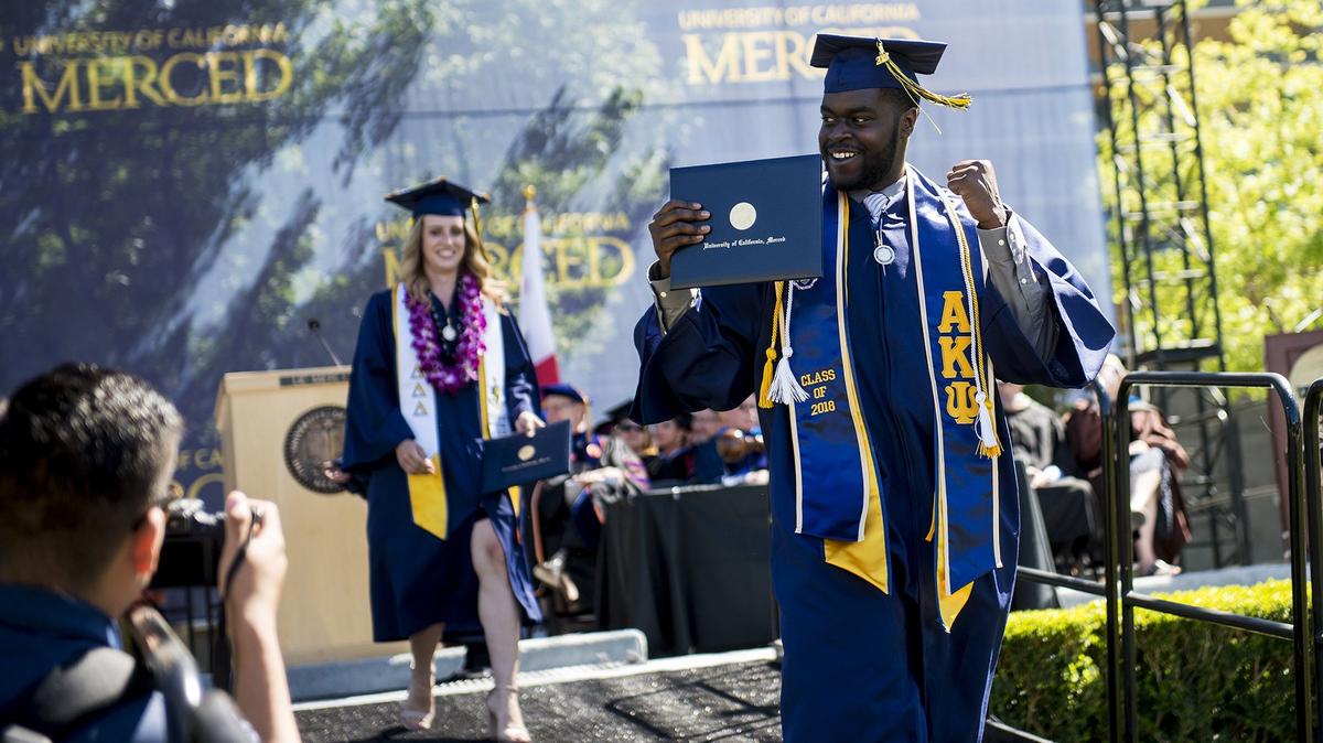 
Graduates celebrate after walking across the stage during the University of California, Merced School of Social Sciences, Humanities and Arts spring commencement in the Carol Tomlinson-Keasey Quad on the UC Merced campus in Merced, Calif., on Saturday, May 12, 2018.
