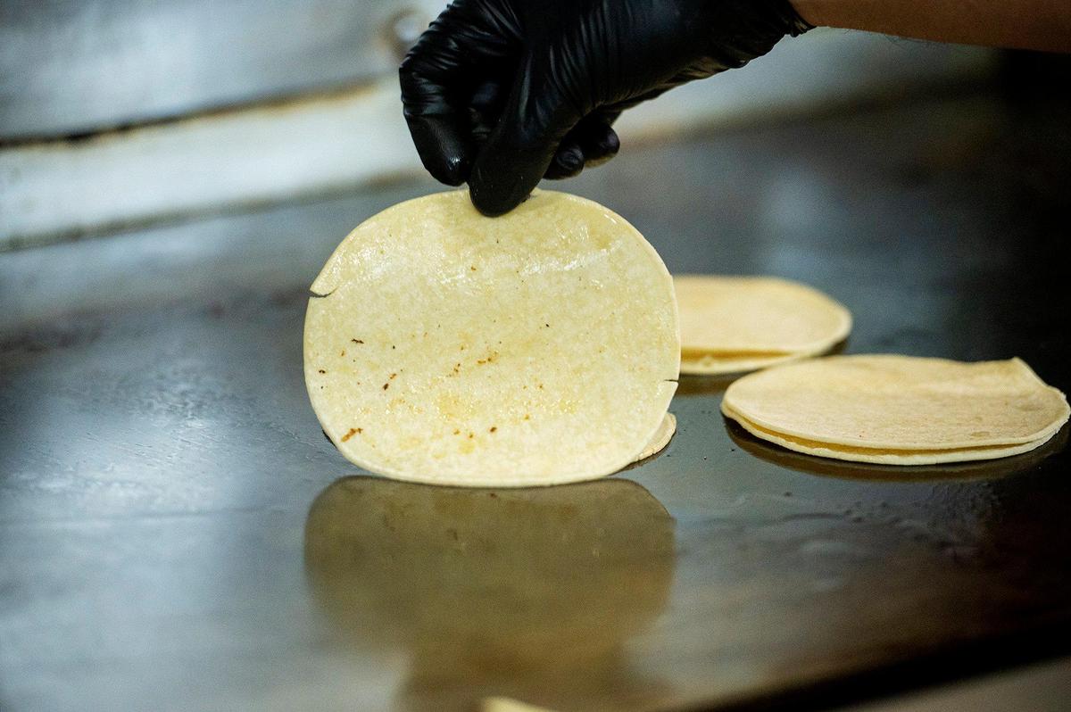 Chayanne Valencia, 33, prepares tortillas for an order at Maria’s Taco Shop in Merced, Calif., on Tuesday, Oct. 15, 2024. The restaurant which is open 24 hours, has offered authentic fast Mexican food to the Merced community for 32 years.