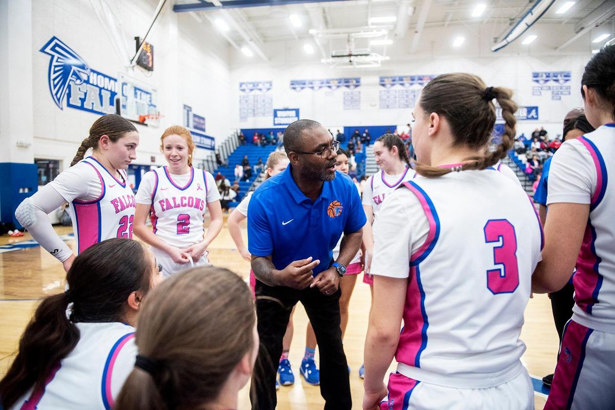 Atwater head coach Leonard Davis speaks to his players between quarters of a CIF Sac-Joaquin Section Division 2 playoff game against Mountain House at Atwater High School in Atwater, Calif., on Wednesday, Feb. 14, 2024. The Falcons beat the Mustangs 95-59.