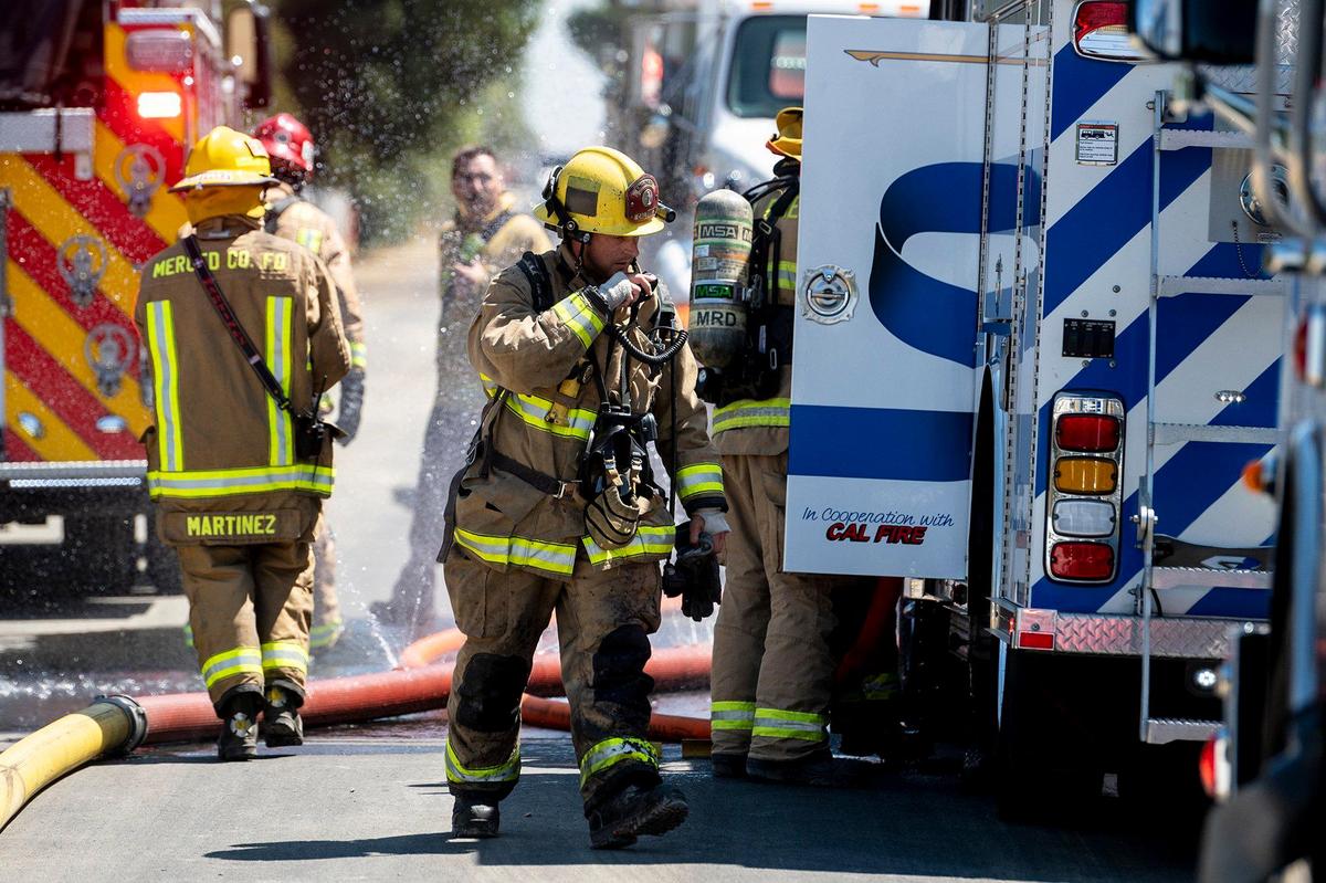 Cal Fire Merced County firefighters and City of Merced firefighters battle a structure fire which damaged two homes in the 1800 block of Dunn Road in Merced County, Calif., on Wednesday, Aug. 23, 2023. Fire officials said the cause of the fire is under investigation.