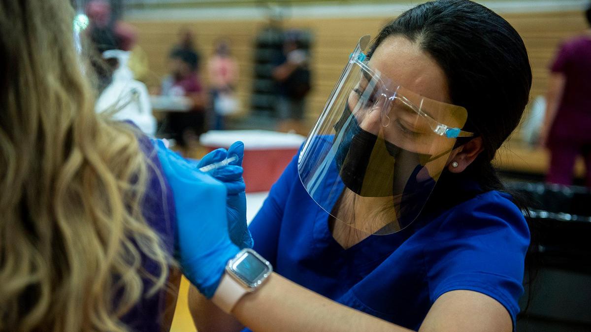 Nurse Myrna Pulido administers the Pfizer COVID-19 vaccine to a student during a vaccination clinic held by the Merced Union High School District in partnership with Castle Family Health Centers for children 12 years of age and older at Livingston High School in Livingston, Calif., on Thursday, May 13, 2021. According to the school district, the clinic was also open to parents and family members who have not yet received the vaccine.
