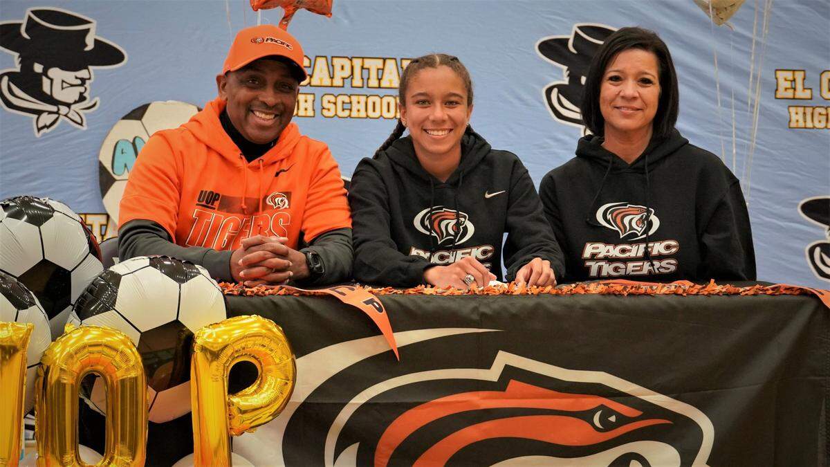 El Capitan High senior Anaya Shelton (center) poses for pictures with her father Brian and mother Rosie after signing her national letter of intent to accept a soccer scholarship to the University of the Pacific on Thursday, Feb. 17, 2022 at El Capitan High School.