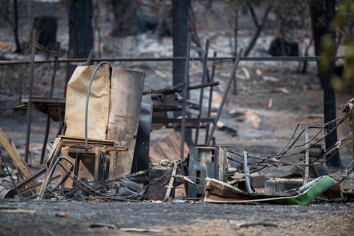 Charred items on a property along Jerseydale Road in Mariposa County, Calif., as firefighters continue to battle the Oak Fire.