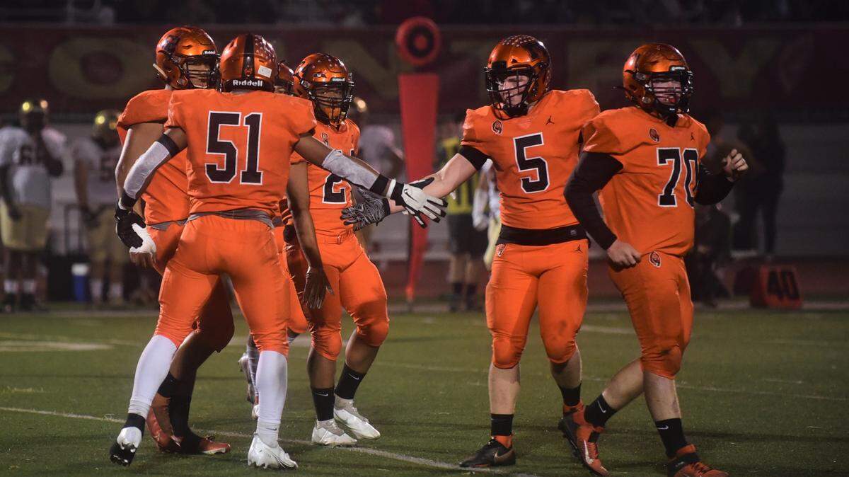 Merced High linebacker Seth Scheidt (5) congratulates teammate Jaylen Thao-Booth (51) after a sack during a game against Golden Valley on Friday, Oct. 29, 2021 at Veterans Stadium in Merced, Calif.