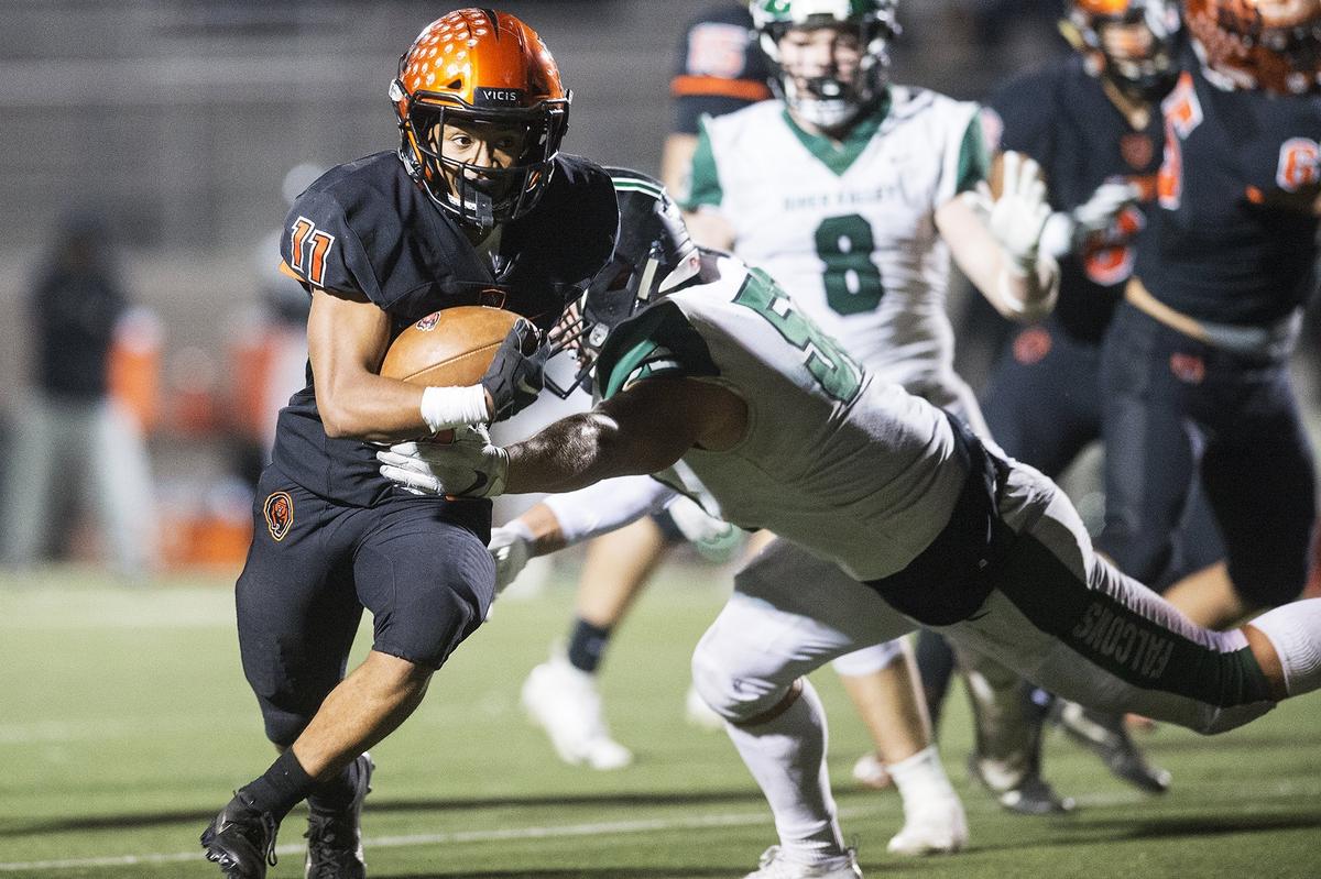 Merced junior Desmond Thompson (11) rushes the ball during a CIF Sac-Joaquin Section Division III playoff game against River Valley at Veterans Stadium in Merced, Calif., on Friday, Nov. 9, 2018. The Falcons beat the Bears 45-40.