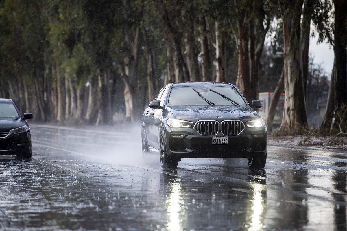 Motorists drive south along M Street during a short rain and hail storm in Merced, Calif., on Monday, Jan. 16, 2023.