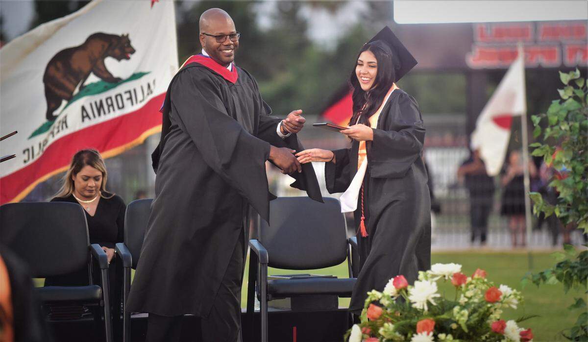 Merced High School graduate Makenzie Gonzalez receives her diploma from Merced principal Marcus Knott during the school’s graduation ceremony on Thursday, June 1, 2023.