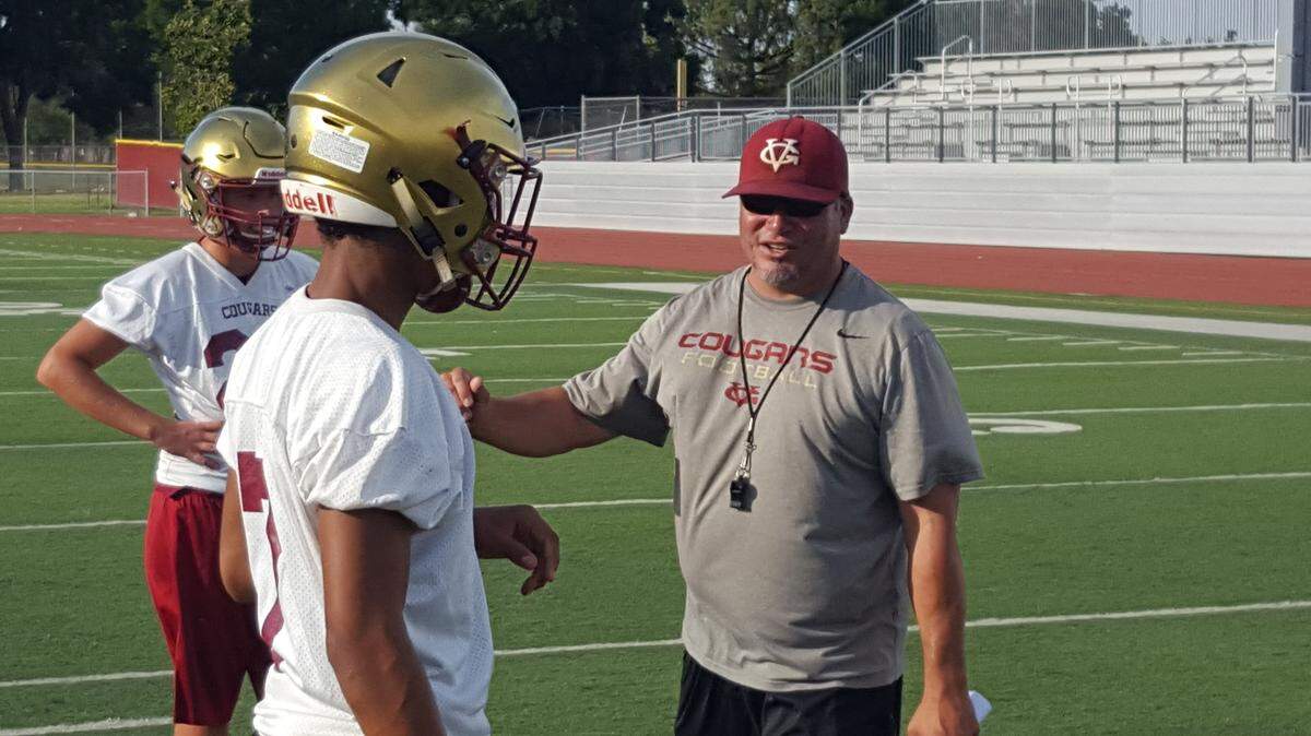 Golden Valley head coach Rick Martinez talks with junior defensive back Avery Townsel during the Cougars' first official practice on Monday evening at Veterans Stadium. Photo by Shawn Jansen/Merced Sun-Star.