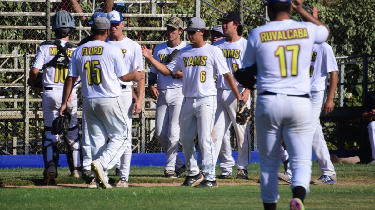 Atwater/Merced Yammer teammates congratulate pitcher Kadon Floro (15) after he pitches a complete game in a 1-0 win over the Clovis Nighthawks on Thursday, July 15, 2021 at Atwater’s Memorial Ballpark.