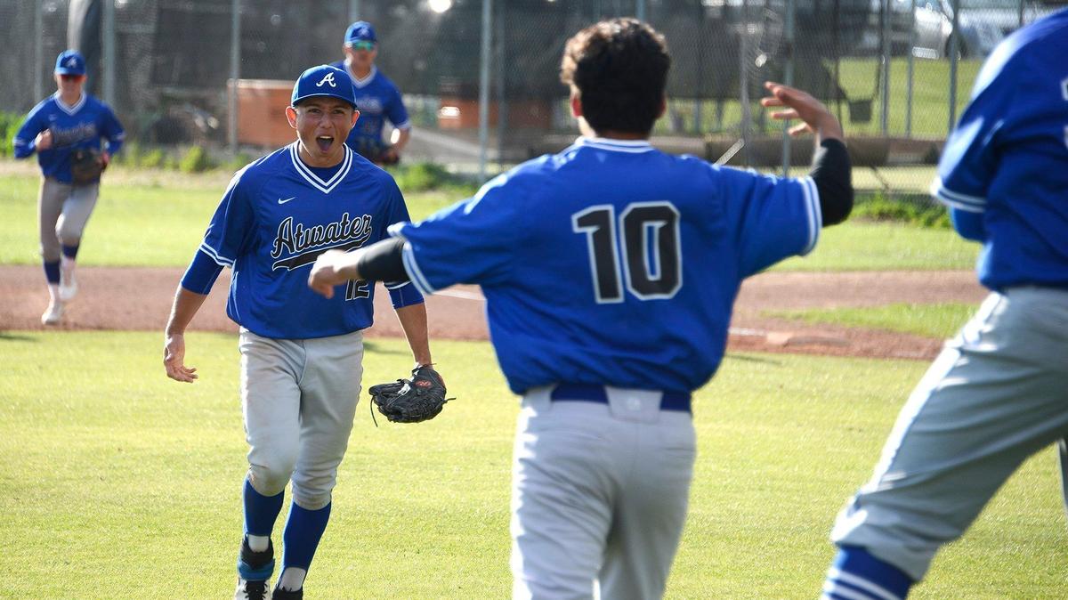 Atwater junior pitcher Nathaniel Silva (12) celebrates with teammates after the final out of a game against Buhach Colony at Buhach Colony High School in Atwater, Calif., on Tuesday, April 2, 2019.