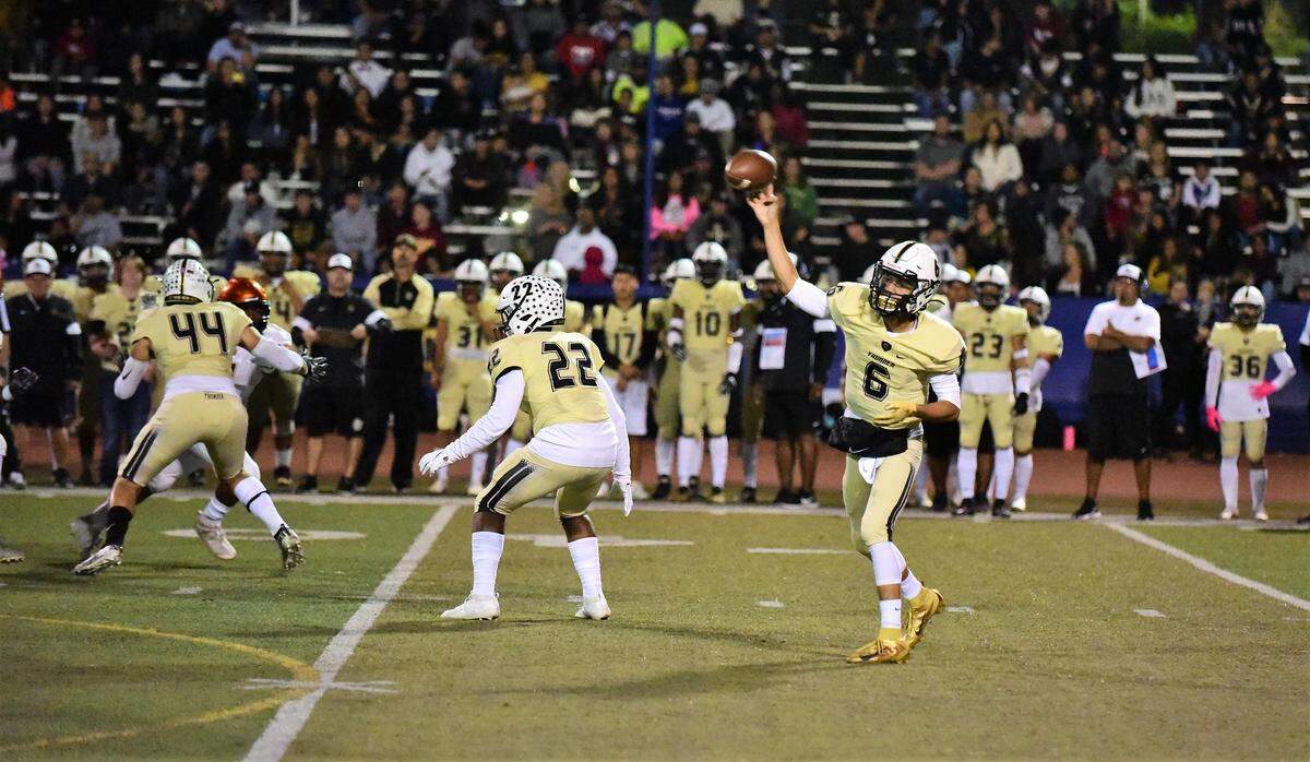Buhach Colony Oscar Smallwood throws a pass during a game against Merced on Friday, Oct. 11, 2019 at Dave Honey Stadium in Atwater, Calif.