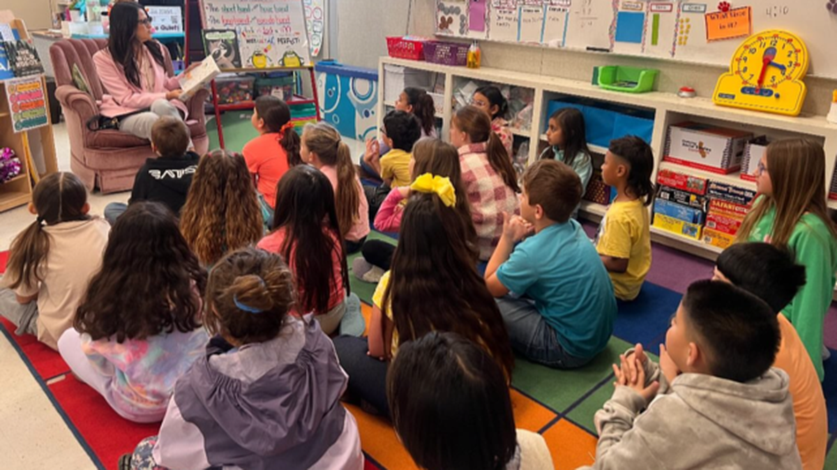 Merced City School District superintendent Julianna Stocking participates in Reading Across America recently at an elementary school. The district is working to improve poor literacy proficiency scores by students.