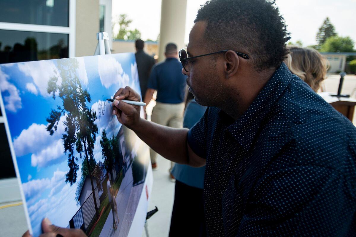 Merced City School District Board President Allen Brooks signs a rendering during a ribbon cutting ceremony to celebrate the opening of a new Administrative Services building on the campus of Franklin Elementary School in Merced County, Calif., on Wednesday, July 24, 2024. The roughly 3,500 square foot facility is equipped to support the Franklin Elementary School staff, students and their families.