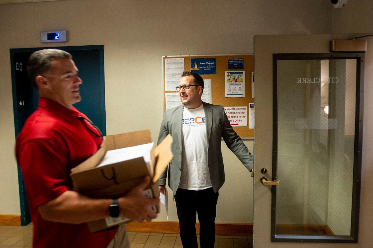 Committee for a Safer Merced chairperson and former City of Merced Mayor, Mike Murphy opens the door to the Merced City Clerk office as the committee submits thousands of voter signatures collected in support of renewing the measure in Merced, Calif., on Monday, Aug. 21, 2023. The half-cent sales tax approved in 2006, funds public safety positions as well as providing resources for emergency responses and road improvements. The measure is set to expire in 2026.