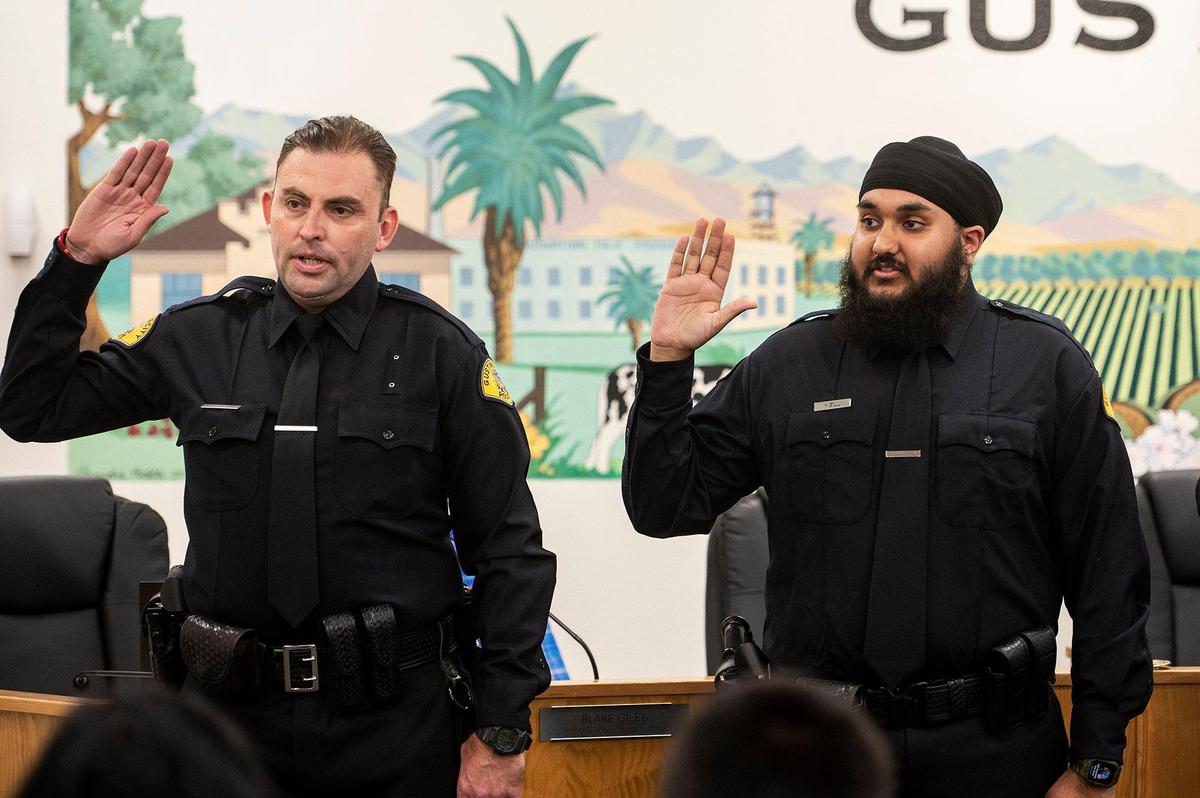 Gustine Reserve Officers Christian Poteat, left, and Harjot Gill, right, are sworn in during a swearing in ceremony for four new Gustine Police Department Reserve Officers in Gustine, Calif., on Tuesday, June 20, 2023.