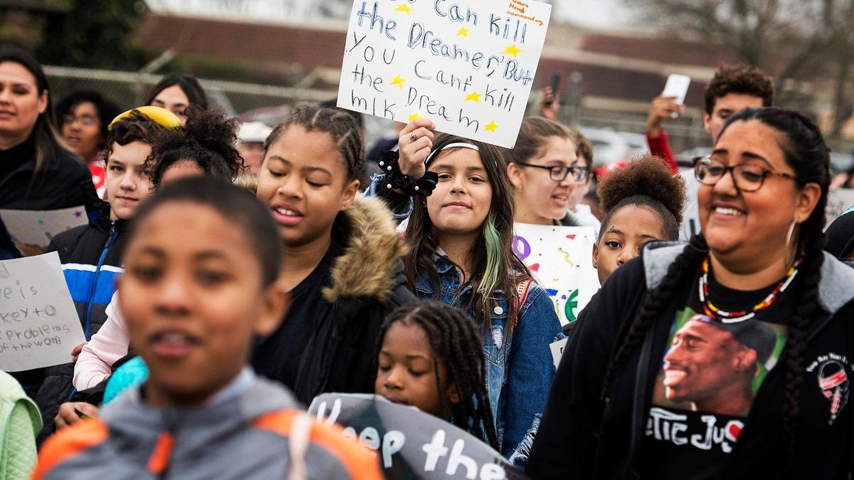 People walk along Martin Luther King Jr. Way during the annual Unity March to honor the legacy of late civil rights trailblazer, Rev. Dr. Martin Luther King Jr., in Merced Calif., on Monday, Jan. 20, 2020.