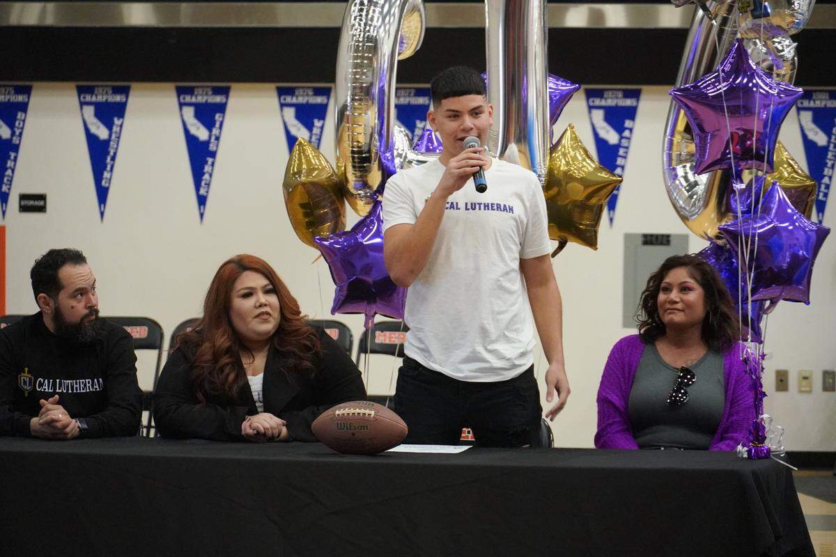 Merced High senior Evahn Perez speaks during a signing ceremony as (from left to right) his father Adrian Perez, step-mother Araceli Perez and mother Vanessa Cervantes look on at Merced High School on Wednesday, Feb. 2, 2022.