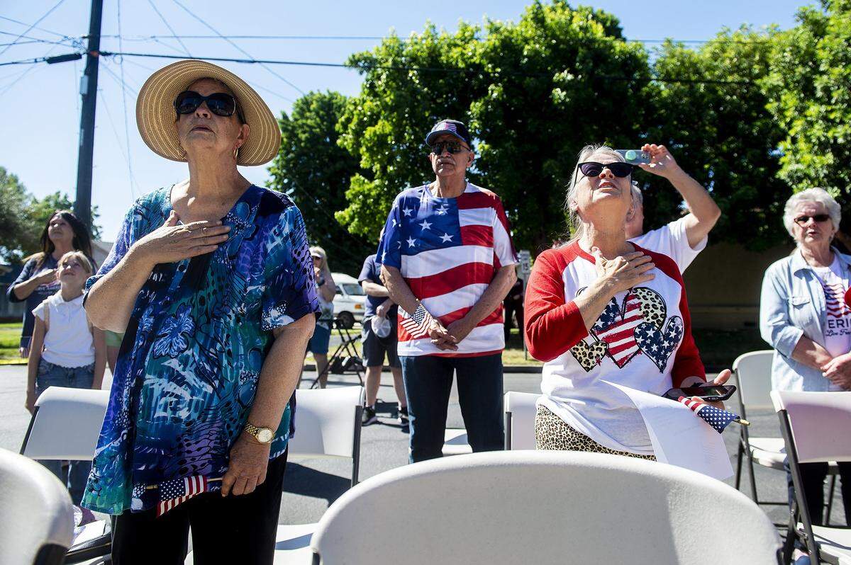 Community members look on and recite the Pledge of Allegiance during a flag raising ceremony inside the Castlewood community in Atwater, Calif., on Tuesday, June 14, 2022. According to Castlewood resident Sharon Wilkerson, the American flag was raised on the communitys new flag pole as a way to pay tribute to families who lived in the former Castle Air Force Base housing as well as fallen soldiers.