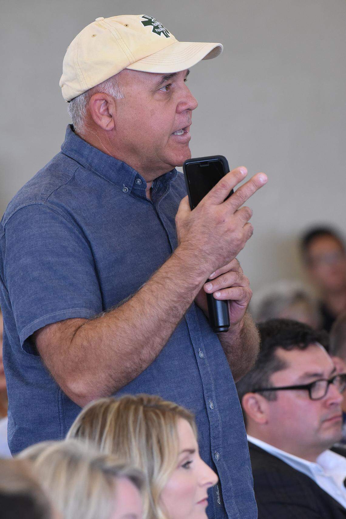 Fresno farmer Mark McAfee asks some dairy questions of U.S. Secretary of Agriculture Sonny Perdue during a town hall meeting in the Germino Building at the Los Banos Fairgrounds on June 28, 2019.