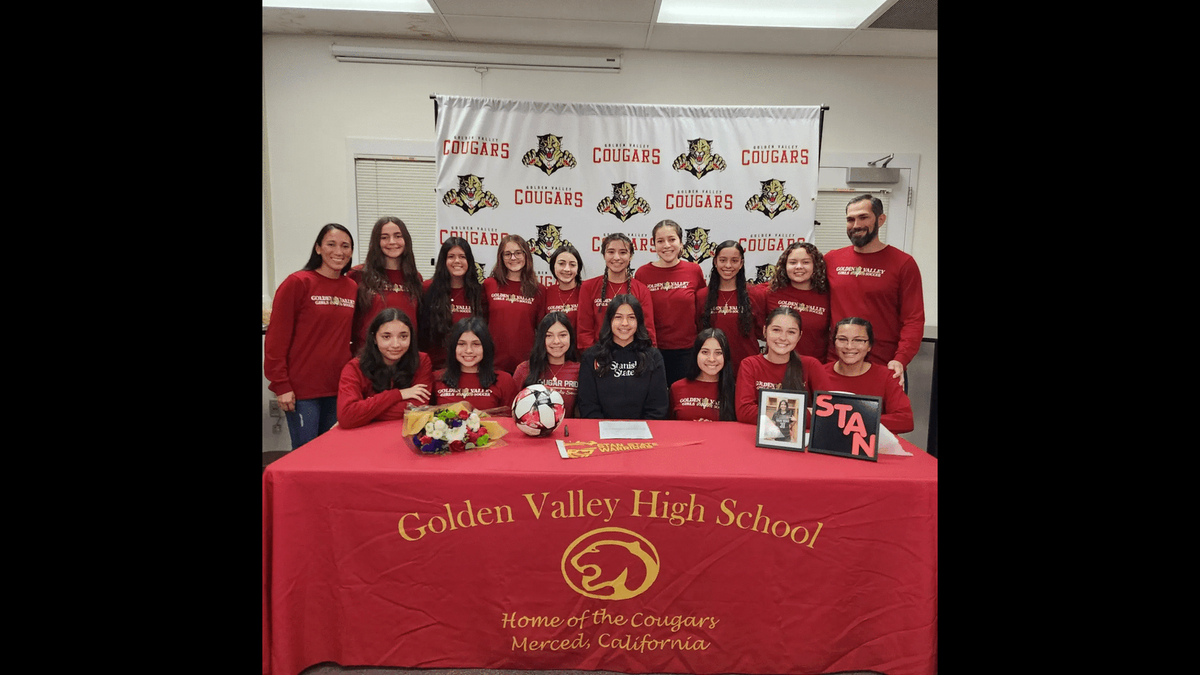 Golden Valley High senior Kayla Perez poses for photos with her Golden Valley teammates and coaches after signing her national letter of intent to play soccer at Stanislaus State on Friday, Jan. 6, 2023.