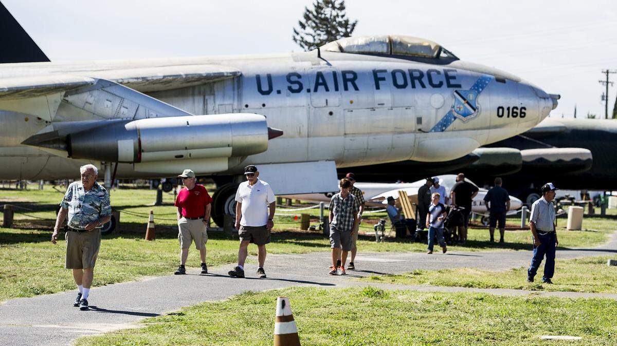 Visitors walk past aircraft during Open Cockpit Day at Castle Air Museum in Atwater, Calif., on Saturday, Sept. 3, 2016. 