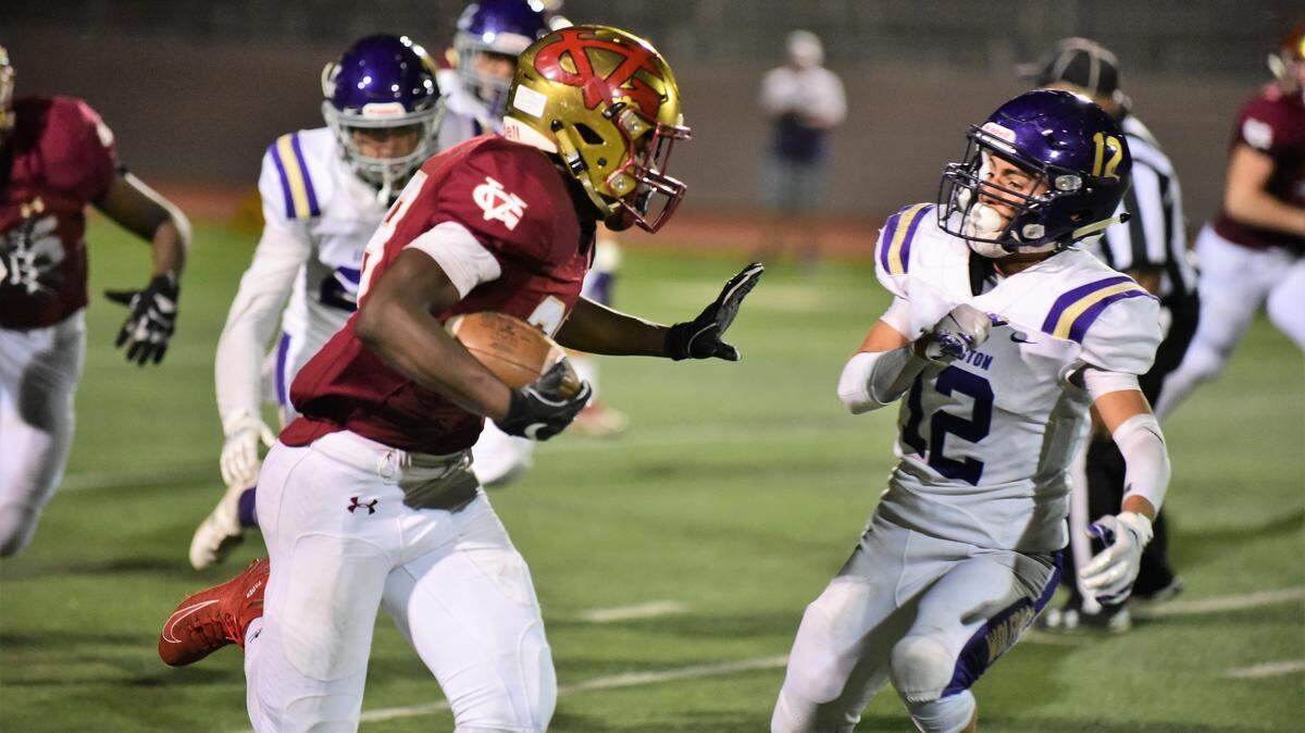 Golden Valley running Jabari Phillips is set to stiff arm Livingston’s Daniel Cruz during a long run on Friday night. Phillips rushed for 257 yards and a school-record six touchdowns.
