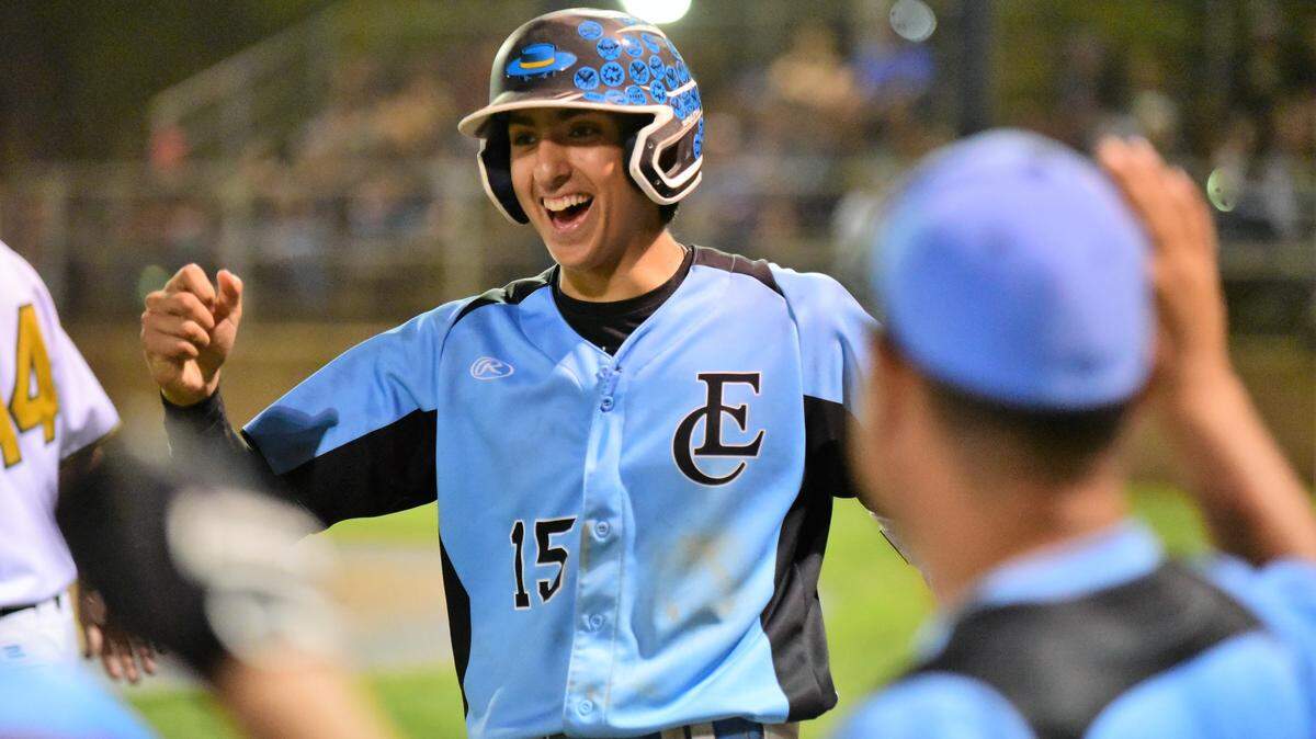 El Capitan junior Chase Minor is greeted at the South dugout after scoring a run during the 10th annual Merced County All-Star Game at Merced College. Minor had two hits and scored two runs.