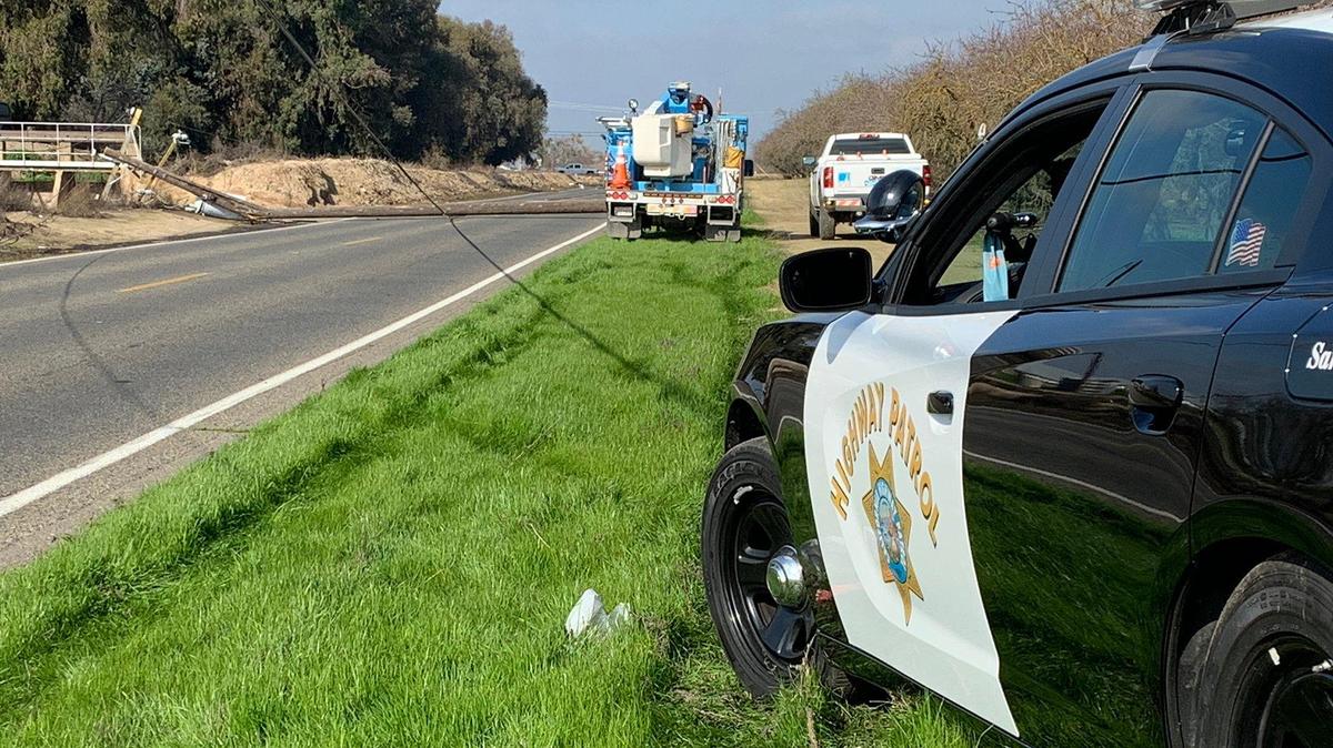 The California Highway Patrol and Pacific Gas and Electric company respond to the scene after a vehicle crashed into a power pole along Shaffer Road causing power poles and energized power lines to fall into the roadway in Merced County, Calif., on Thursday, Jan. 30, 2020. According to the CHP, Shaffer Road is closed between Mercedes Avenue and Palm Avenue. The road is expected to remain closed until about 4 a.m. Friday. Image courtesy of the California Highway Patrol.