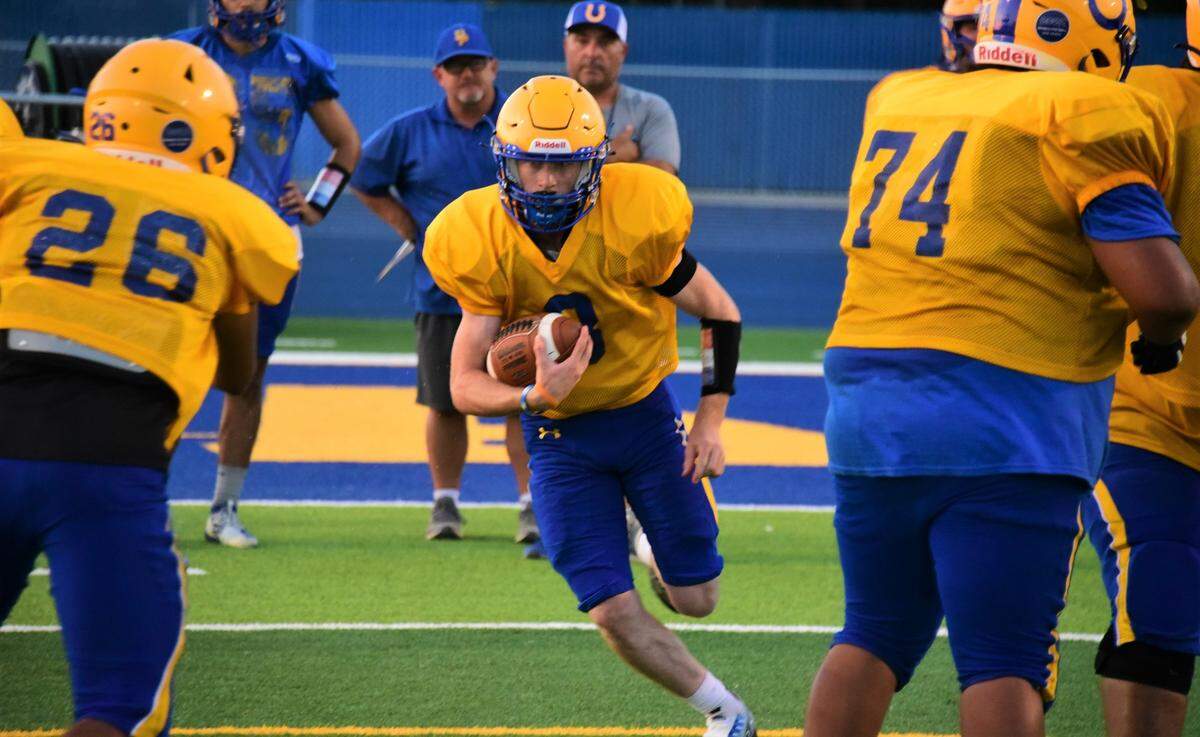 Dos Palos High School running back Drake Hannagan runs the ball during practice on Tuesday, Aug. 16, 2022.