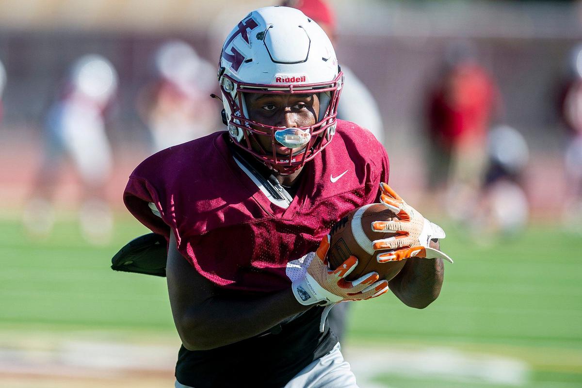 Deavon Williams sprints upfield after catching a pass during football practice at Golden Valley High School in Merced, Calif., on Tuesday, Aug. 20, 2024.