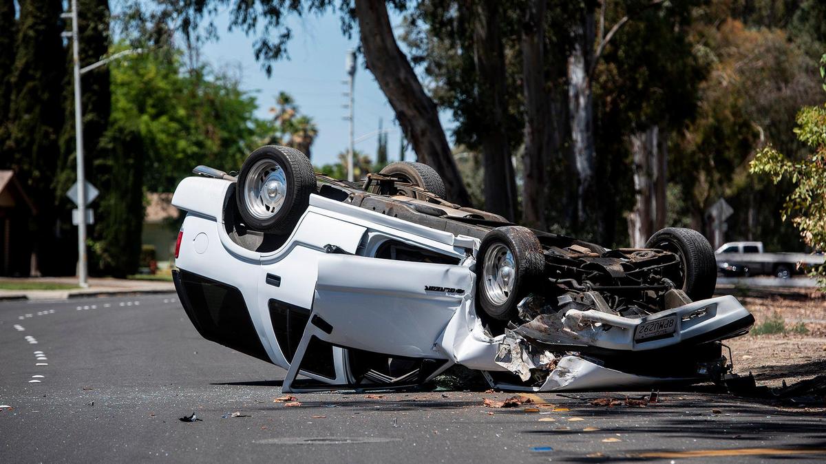 Merced police respond to the scene of a rollover collision in the southbound lanes of M Street, south of Buena Vista Drive in Merced, Calif., on Tuesday, May 18, 2021.