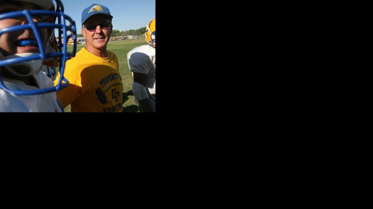 ERIC PAUL ZAMORA / THE FRESNO BEE - Coach Mike Sparks, center, mingles with team members during practice at Dos Palos High School. He plans to retire at season's end.