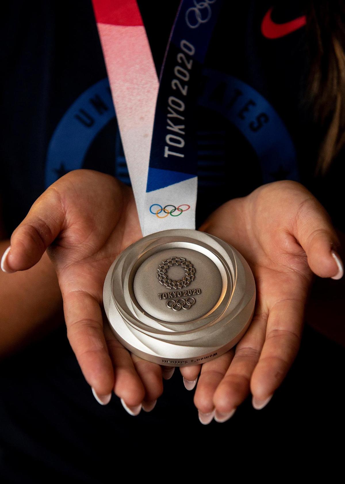 Madilyn “Bubba” Nickles shows off her silver medal she won while playing softball for Team USA during the 2020 Tokyo Olympics, at her home in Atwater, Calif., on Tuesday, Aug. 10, 2021. Nickles was named National Gatorade Player of the Year during her senior year at Merced High School and played college softball for the UCLA Bruins, helping lead the team to a NCAA National Championship in 2019.