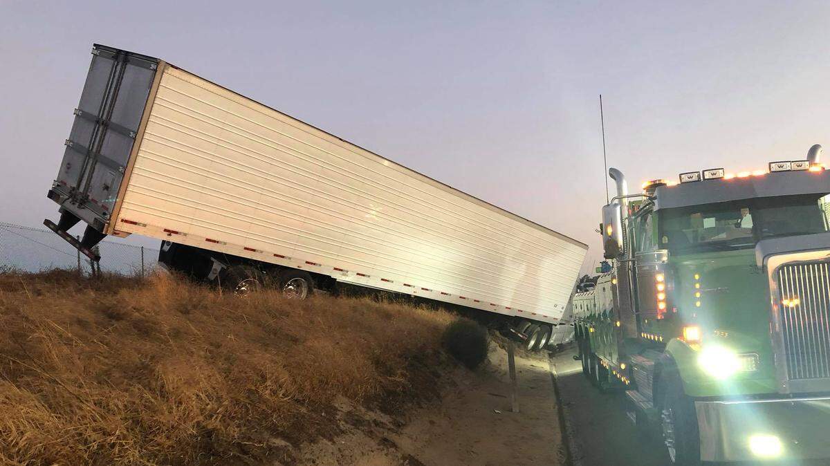 A big rig sits on the west shoulder of Highway 99 the morning of Monday, Sept. 17, 2018, after it reportedly drifted from the northbound lanes across the median and across the southbound lanes of the highway, according to California Highway Patrol.