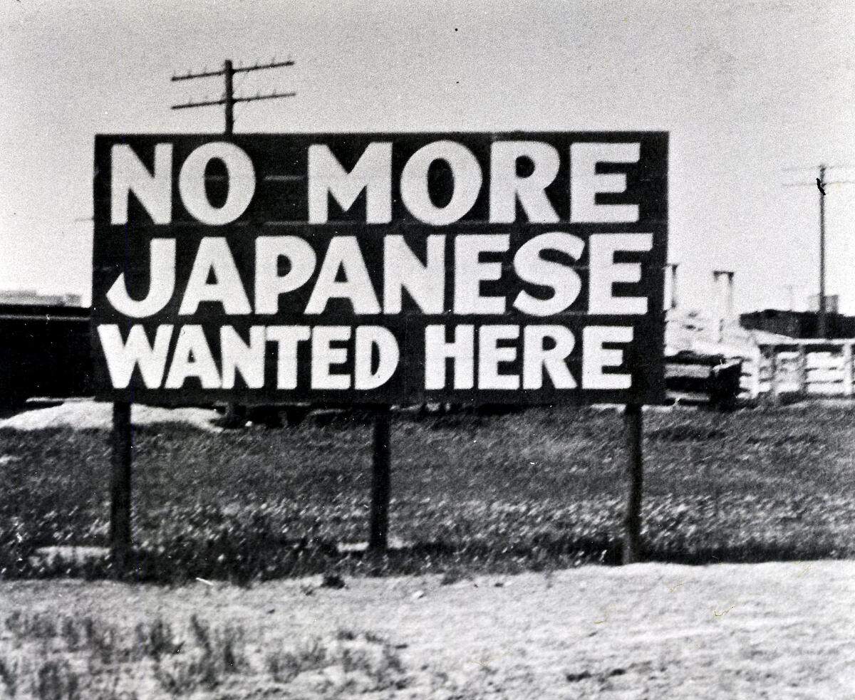 PHOTO COURTESY OF THE MERCED COUNTY HISTORICAL SOCIETY A sign placed at the entrance to Livingston in 1920 serves as an unsettling reminder of the sentiment which allowed some 5,000 Japanese-Americans from Merced County to be interned at the Merced County Fairgrounds in 1942. A lawmaker is putting forth a resolution for the Legislature to apologize for the role in the internment.