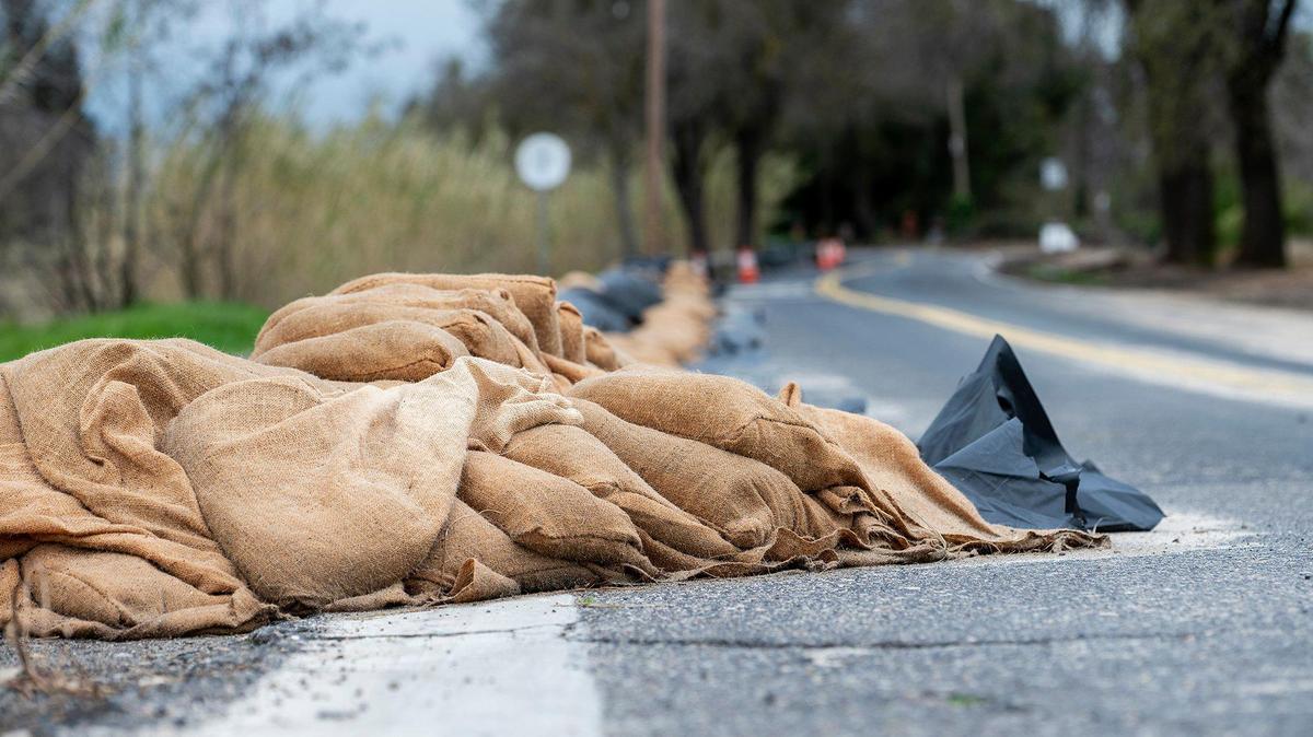 Sandbags line West North Bear Creek Drive in Merced, Calif., on Tuesday, March 14, 2023.