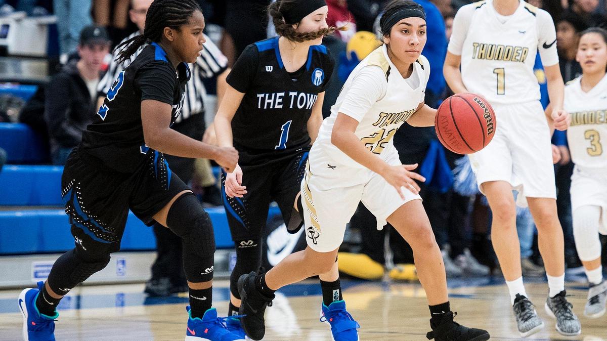 Buhach Colony junior Cassandra Gutierrez (22) gets past Atwater sophomore Amoni Claiborne (32) and senior Kelsey Valencia (1) during a game at Atwater High School in Atwater, Calif., on Thursday, Jan. 17, 2019.