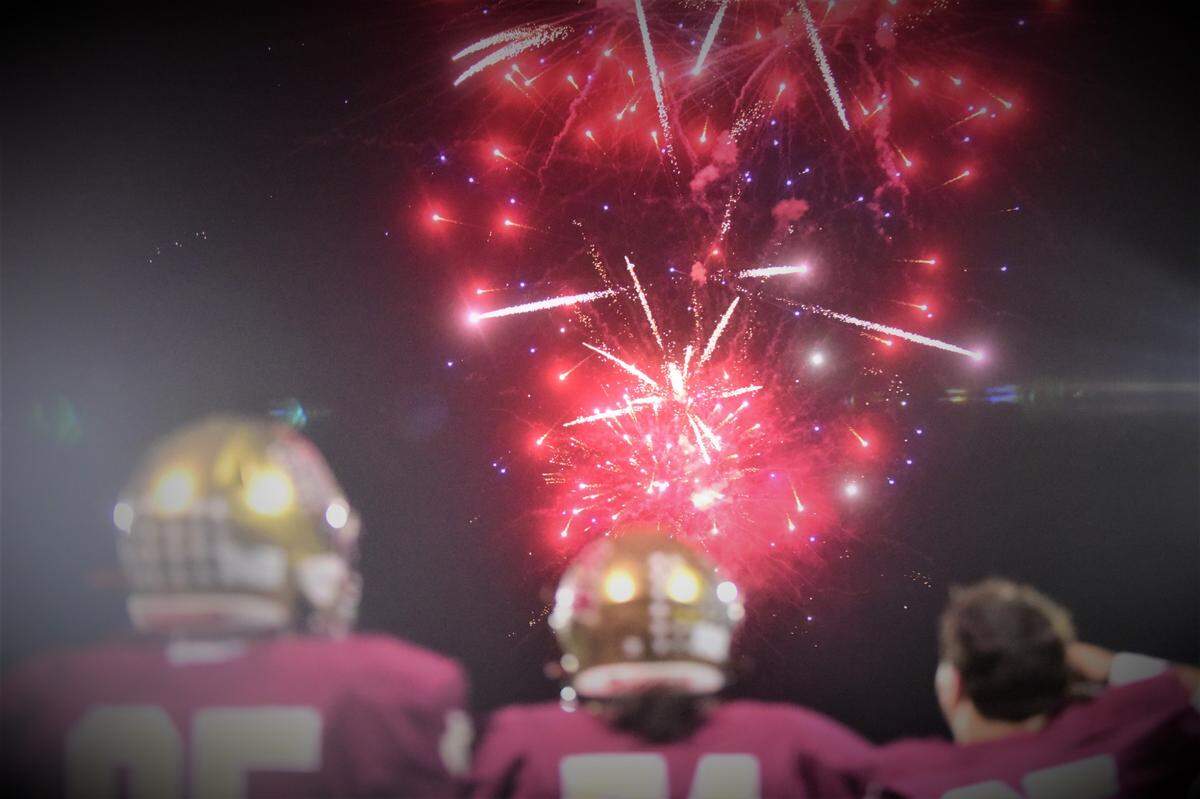 Golden Valley High football players watch the fireworks go off during the homecoming ceremony at halftime on Friday, Oct. 7, 2022 at Veterans Stadium in Merced, Calif.
