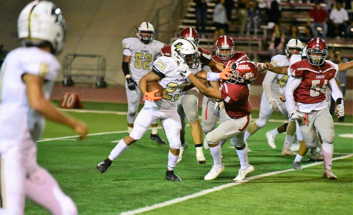 Buhach Colony’s Youlas Dickson uses a stiff arm to avoid a tackle against a Patterson defender during a game against the Tigers on Friday, Sept. 20, 2019.