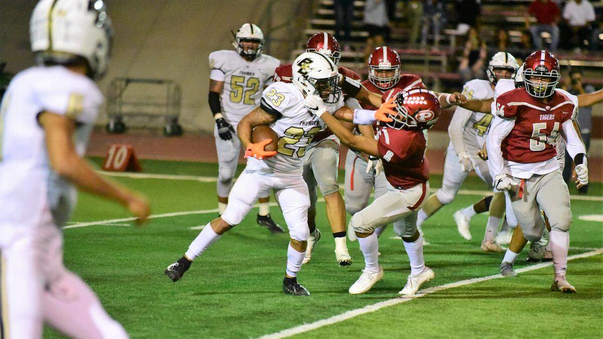 Buhach Colony’s Youlas Dickson uses a stiff arm to avoid a tackle against a Patterson defender during a game against the Tigers on Friday, Sept. 20, 2019.