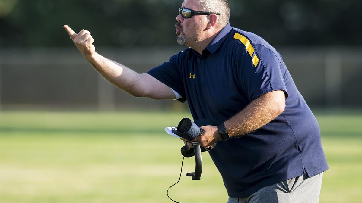 Merced College head coach Bob Casey yells to his players during a scrimmage against Modesto Junior College at Stadium ’76 in Merced, Calif., on Wednesday, Aug. 22, 2018.