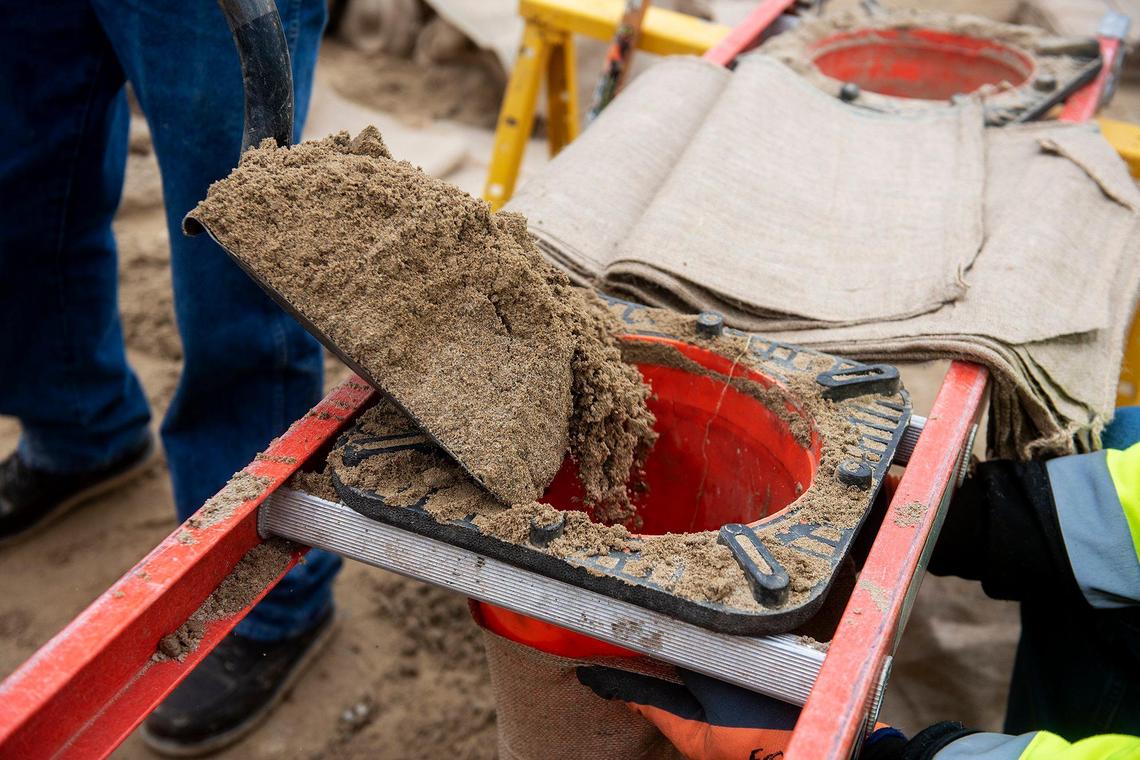 City of Merced employees fill sandbags to be used along Bear Creek while preparing for upcoming rainstorms in Merced, Calif., on Thursday, March 9, 2023.