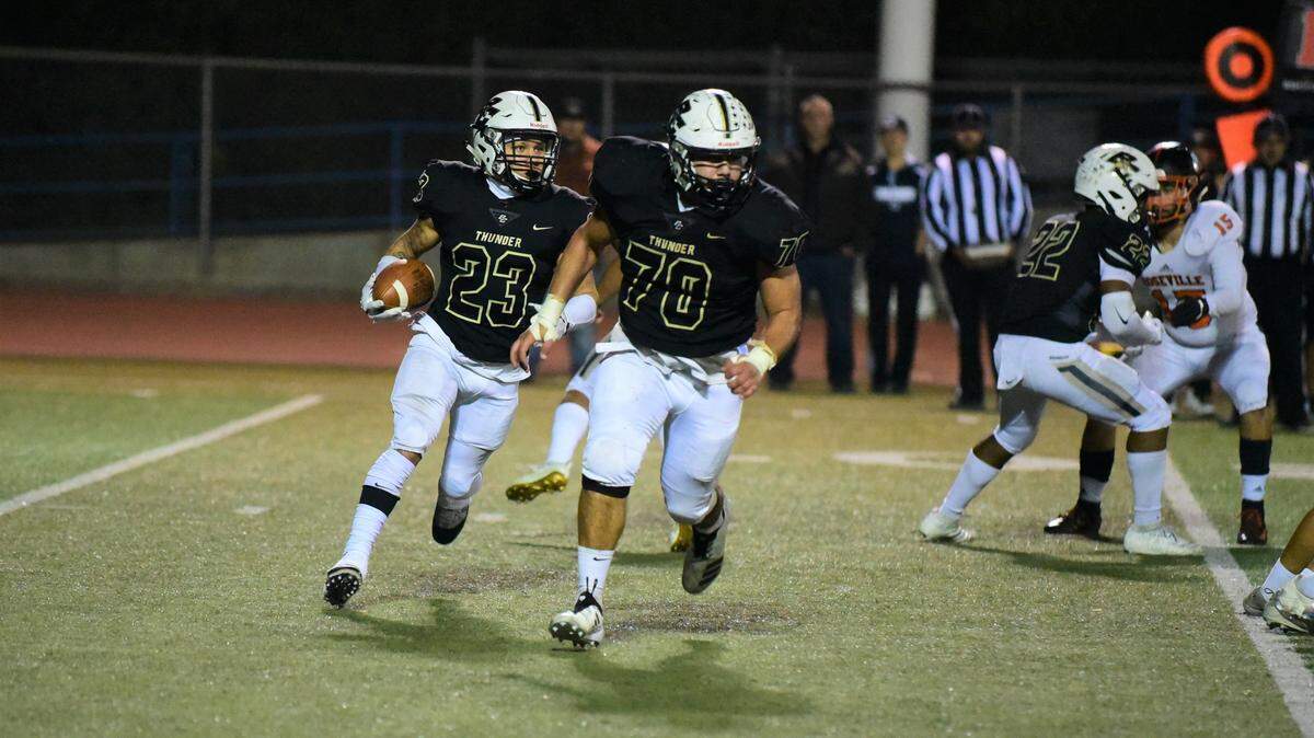 Buhach Colony senior Youlas Dickson (23) follows teammate Tomas Sandoval around the edge during a playoff game against Roseville on Friday, Nov. 15, 2019.