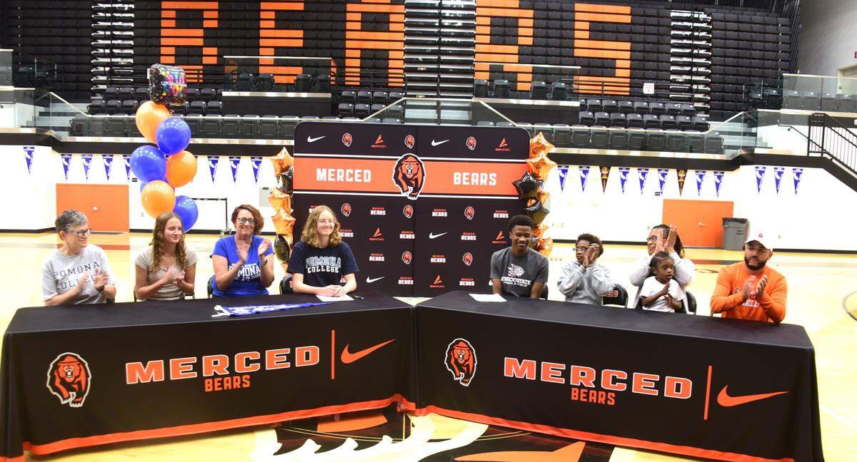Merced High track athletes Elsa Van Dyke (center) and Donovan Marshall (center right) sign their national letter of intent to compete at Pomona College and Chico State, respectively, during a ceremony on Tuesday, May 28, 2024. They are joined from left to right mother Nella Van Dyke, sister Sadie, mother Irenee Beattie and Marshall’s brother Brayden, mother Krystal Johnson and brother Jermamy and Merced coach Joe Villanueva.