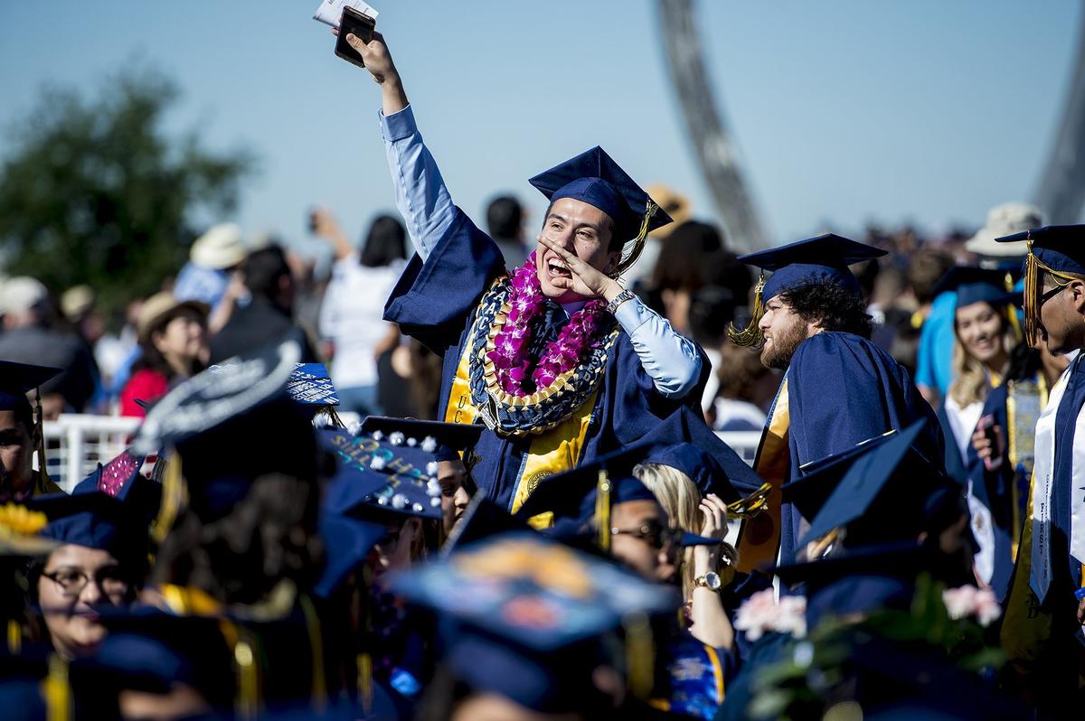 Economics major Isaac Limon, 22, of Los Angeles, celebrates during the University of California, Merced School of Social Sciences, Humanities and Arts spring commencement in the Carol Tomlinson-Keasey Quad on the UC Merced campus in Merced, Calif., on Saturday, May 12, 2018.