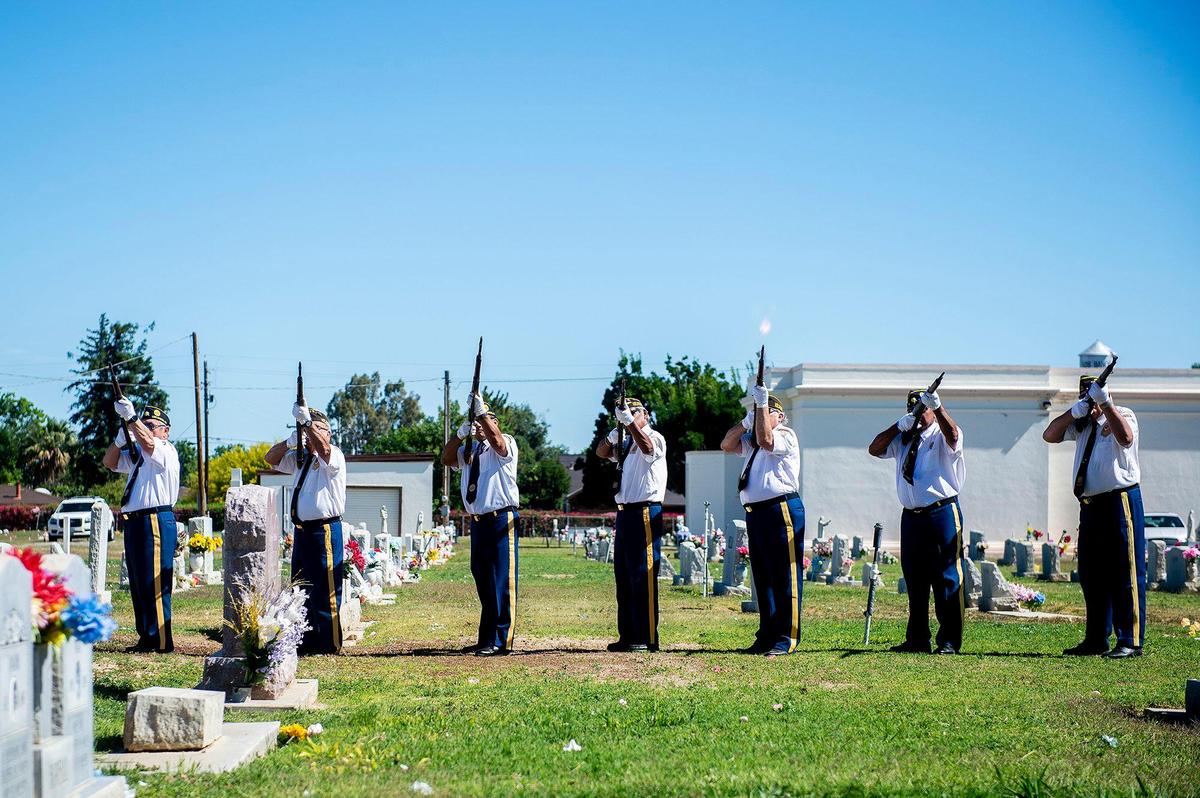 Members of the V.F.W. Post 2487 Honor Guard performs a 21 Gun Salute, during a Memorial Day ceremony at the Los Banos Cemetery, located at 16575 Center Avenue in Los Banos, Calif., on Monday, May 30, 2022.