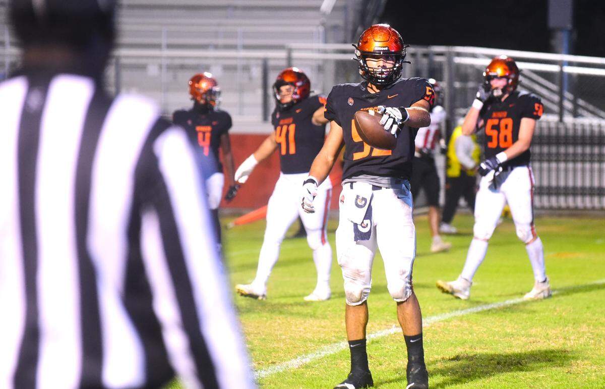 Merced High School senior Jalonn Booth (52) holds the ball after recovering a fumble during the Bears’ 47-0 playoff win on Friday, Nov. 3, 2023 at Cathie Hostetler Stadium in Merced, Calif.