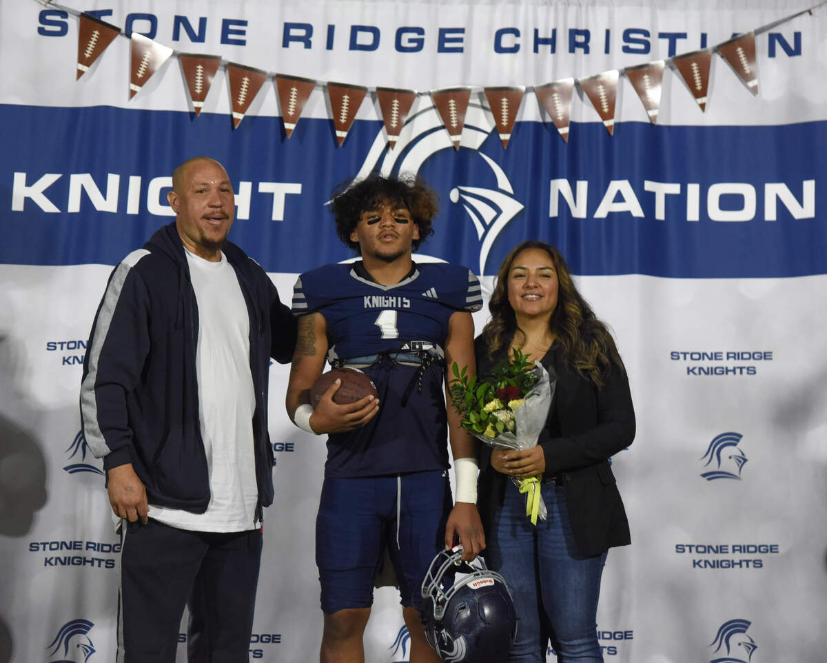 Stone Ridge Christian senior Daijon O’Neil poses with family before Friday night’s game against Mariposa County in Franklin. O’Neil scored both of the Knights’ touchdowns in a 14-11 victory.