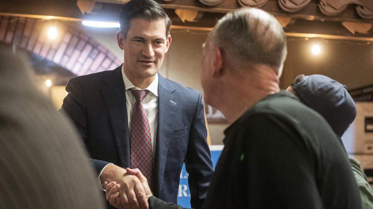 Incumbent Merced mayoral candidate Matthew Serratto, left shakes hands with supporters during an election night watch party in Merced, Calif., on Tuesday, Nov. 5, 2024.