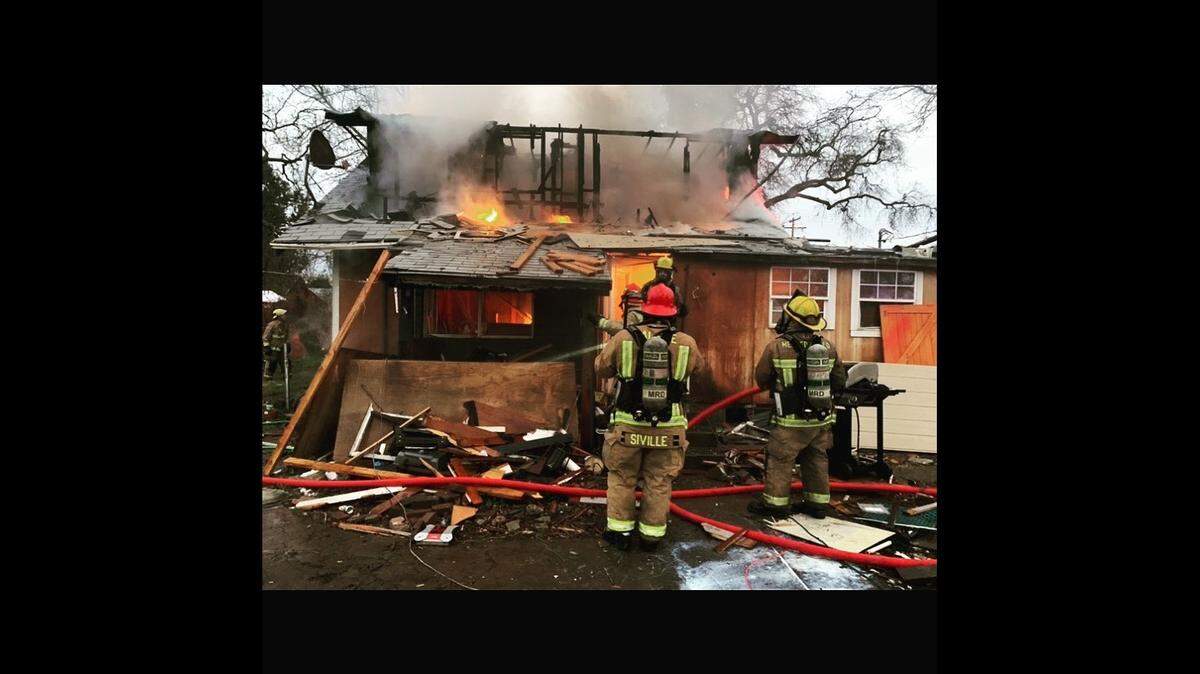 Merced County firefighters battling a structure fire in Snelling, Calif. on Tuesday, Feb. 2, 2021.